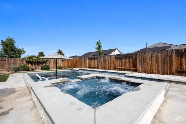 view of pool featuring a fenced backyard, a fenced in pool, and an in ground hot tub