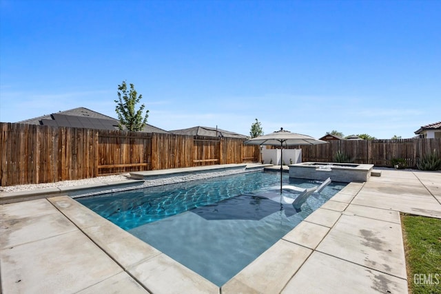 view of swimming pool with a fenced backyard, a pool with connected hot tub, and a patio