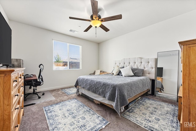bedroom with carpet floors, visible vents, a ceiling fan, and baseboards
