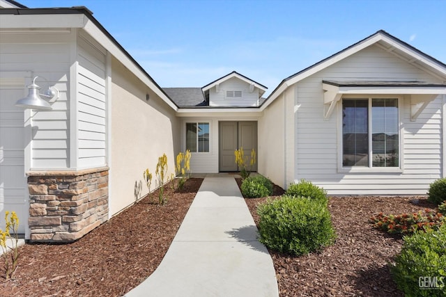 entrance to property with stone siding