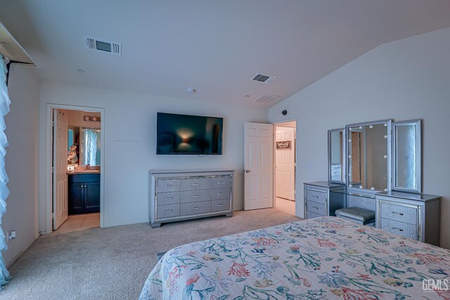 615 Welch Ave, Bakersfield, CA 93307 - bedroom with light colored carpet, vaulted ceiling, and ensuite bathroom