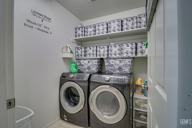 615 Welch Ave, Bakersfield, CA 93307 - washroom with washer and dryer, tile patterned floors, and baseboards