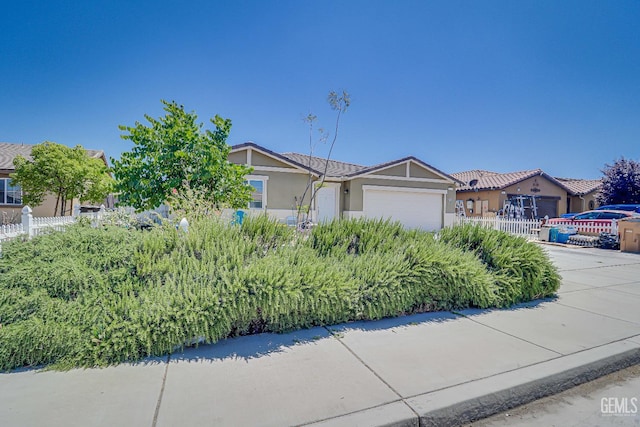 615 Welch Ave, Bakersfield, CA 93307 - view of front of property with an attached garage and stucco siding