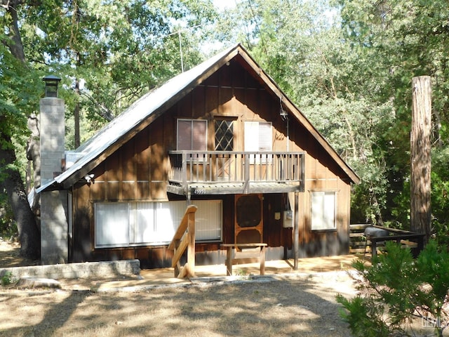 rear view of property featuring a balcony