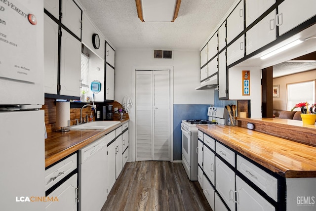 kitchen featuring wood counters, white cabinetry, white appliances, and sink