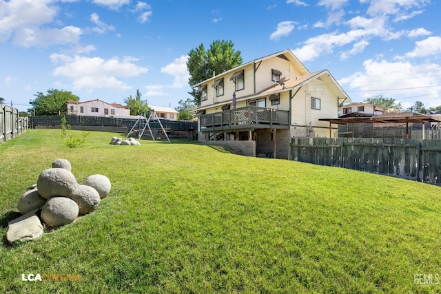 view of yard featuring a playground and a deck