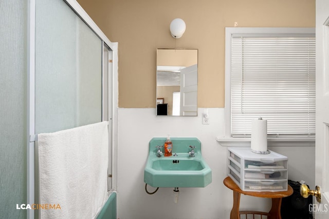 bathroom with an enclosed shower and sink