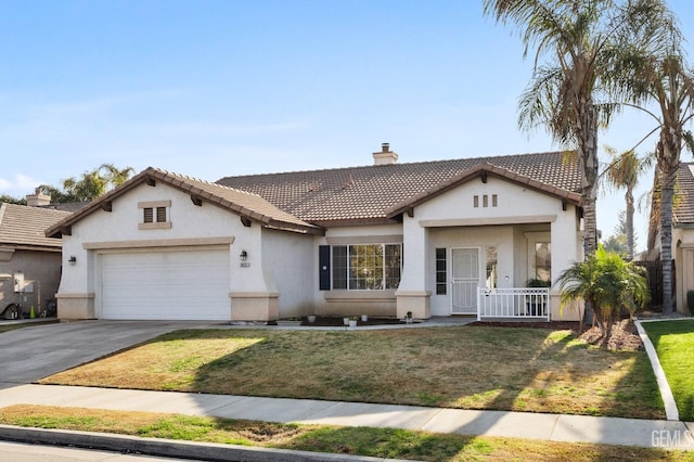 view of front of home featuring a front yard and a garage