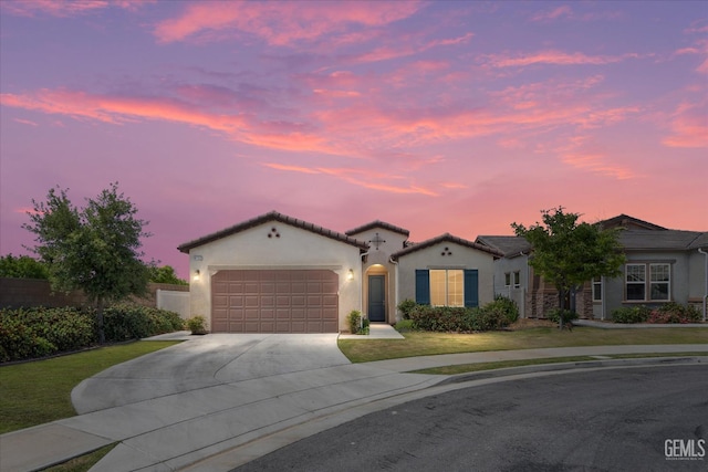 9702 Petersburg Pl, Bakersfield, CA 93306 - mediterranean / spanish-style home with stucco siding, concrete driveway, a garage, and a lawn