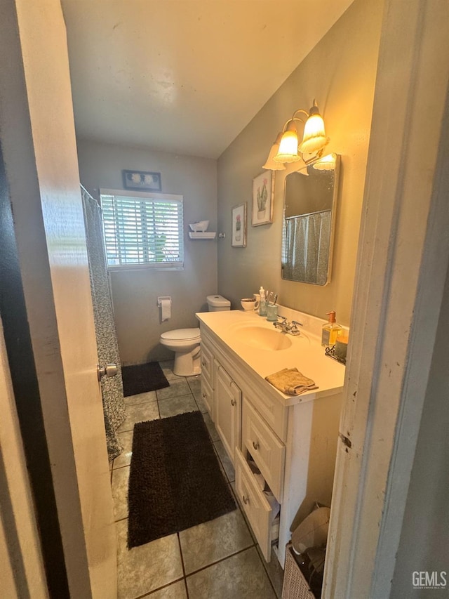 full bathroom with a shower with curtain, vanity, tile patterned flooring, and toilet