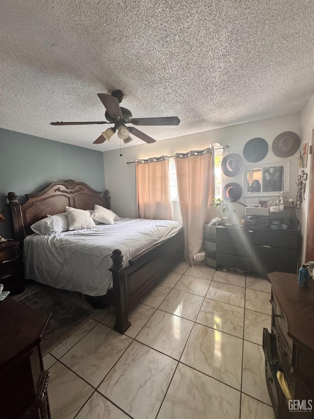 bedroom featuring marble finish floor, a textured ceiling, and ceiling fan