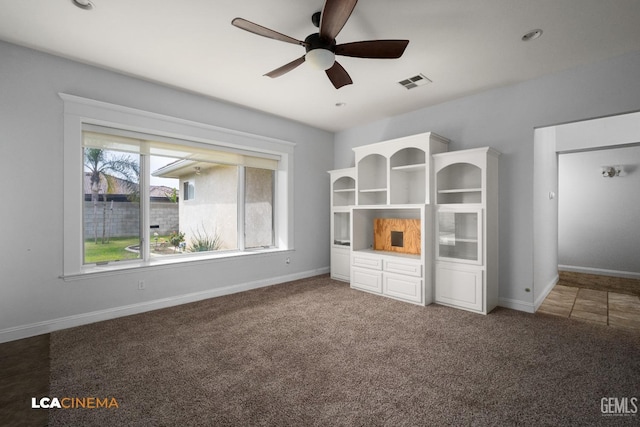 unfurnished bedroom with ceiling fan, carpet floors, visible vents, and baseboards