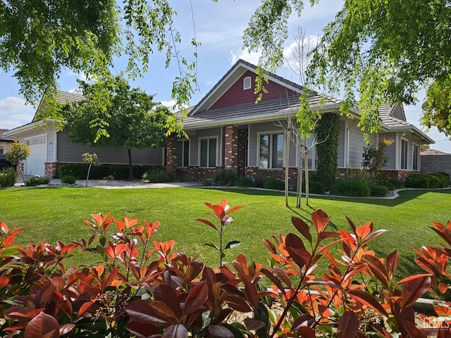 view of front of property with brick siding and a front yard