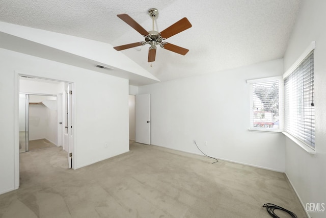 6008 Alderpointe St, Bakersfield, CA 93313 - unfurnished bedroom with lofted ceiling, carpet flooring, a walk in closet, a ceiling fan, and a textured ceiling