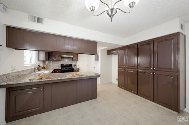 6008 Alderpointe St, Bakersfield, CA 93313 - kitchen featuring black stove, a peninsula, a chandelier, a sink, and dark brown cabinetry