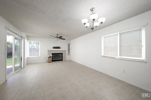 6008 Alderpointe St, Bakersfield, CA 93313 - unfurnished living room featuring a ceiling fan, a fireplace, a textured ceiling, and a chandelier