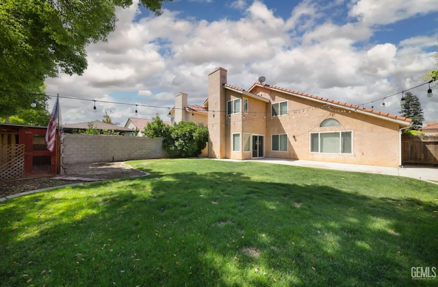 6008 Alderpointe St, Bakersfield, CA 93313 - rear view of property with stucco siding, a tiled roof, and a patio area