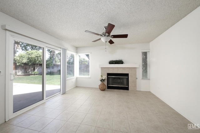 6008 Alderpointe St, Bakersfield, CA 93313 - unfurnished living room featuring a textured ceiling, ceiling fan, a tile fireplace, and light tile patterned flooring