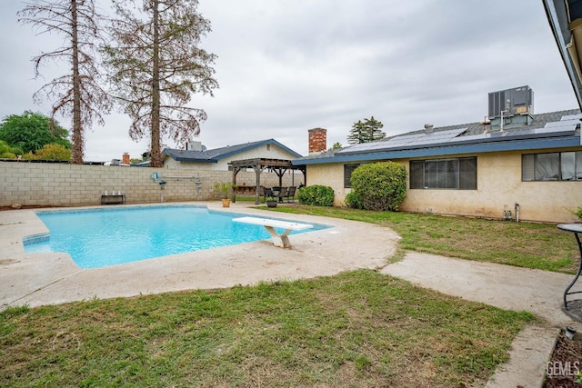 view of pool featuring a pergola, a fenced backyard, a diving board, a fenced in pool, and a patio
