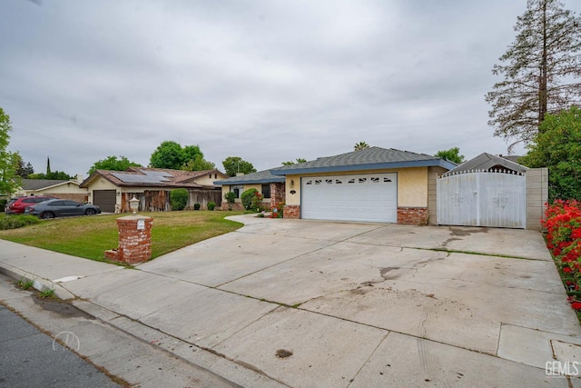 ranch-style house featuring a gate, an attached garage, driveway, brick siding, and a front yard