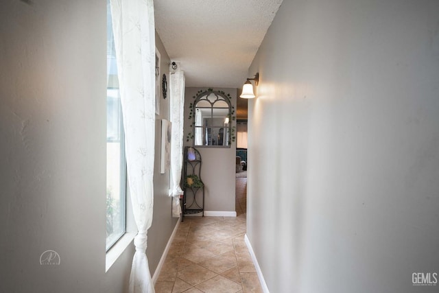 corridor featuring a textured ceiling
