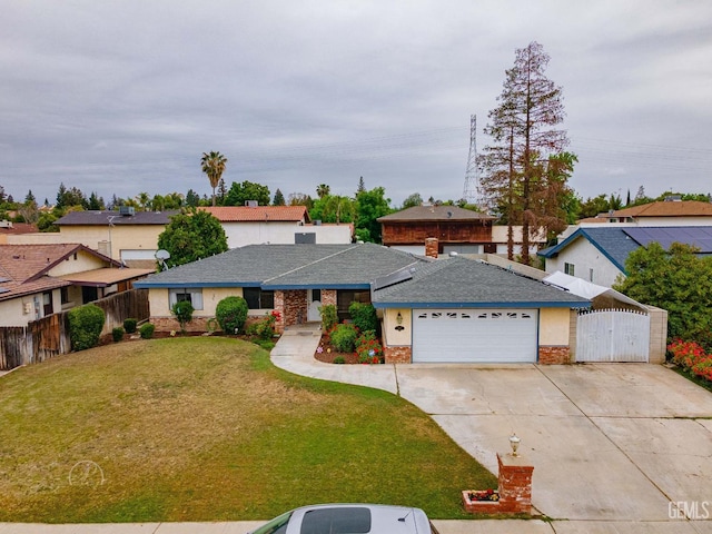 view of front facade featuring a gate, fence, driveway, a front yard, and a garage
