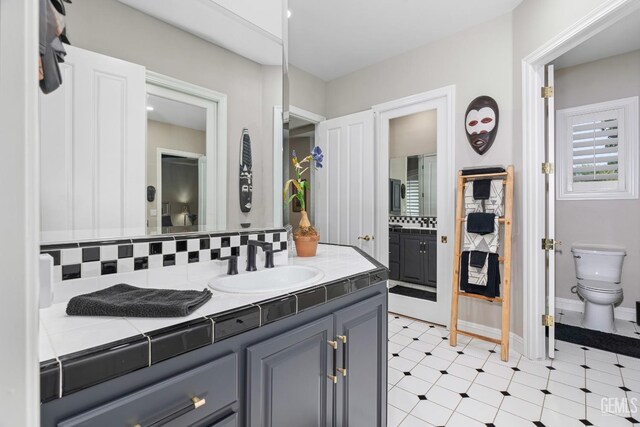 1904 Cricket Park Ct, Bakersfield, CA 93311 - bathroom featuring decorative backsplash, toilet, vanity, and tile patterned floors