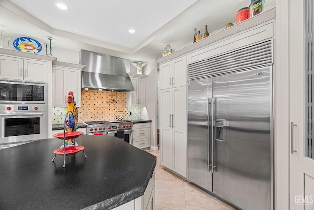 1904 Cricket Park Ct, Bakersfield, CA 93311 - kitchen with built in appliances, wall chimney exhaust hood, dark countertops, backsplash, and recessed lighting