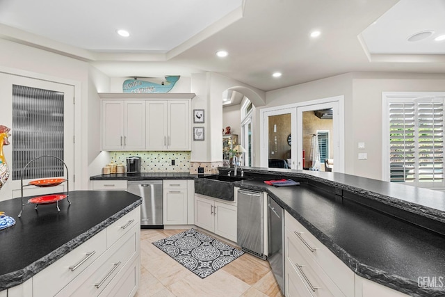 1904 Cricket Park Ct, Bakersfield, CA 93311 - kitchen featuring a sink, stainless steel dishwasher, tasteful backsplash, french doors, and arched walkways