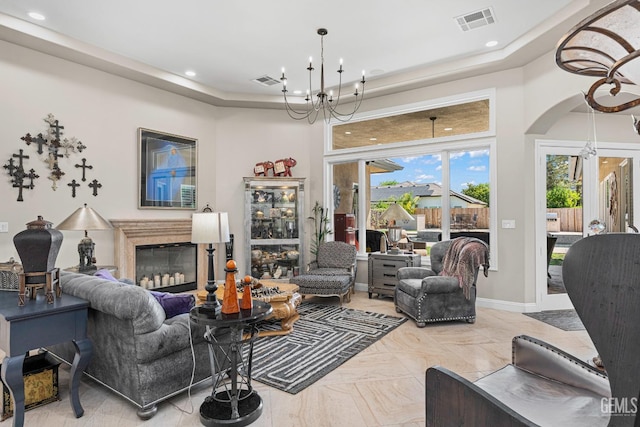 1904 Cricket Park Ct, Bakersfield, CA 93311 - living room with a chandelier, recessed lighting, a glass covered fireplace, arched walkways, and baseboards