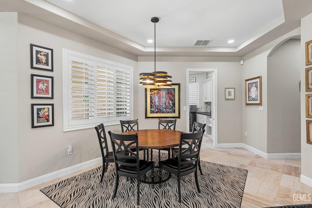 1904 Cricket Park Ct, Bakersfield, CA 93311 - dining area featuring arched walkways, a tray ceiling, recessed lighting, and baseboards