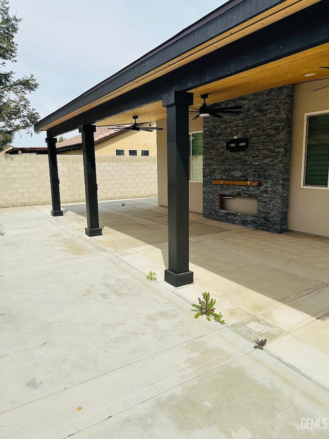 exterior space featuring ceiling fan and fence