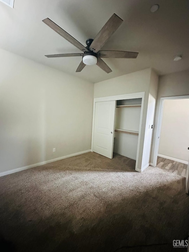 unfurnished bedroom with ceiling fan, a closet, baseboards, and carpet floors