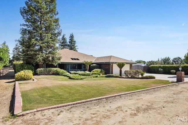 ranch-style house featuring a garage and driveway