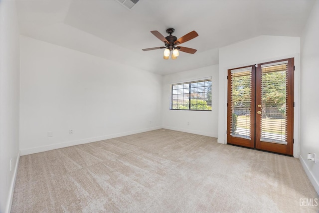 carpeted spare room featuring french doors, baseboards, and a ceiling fan