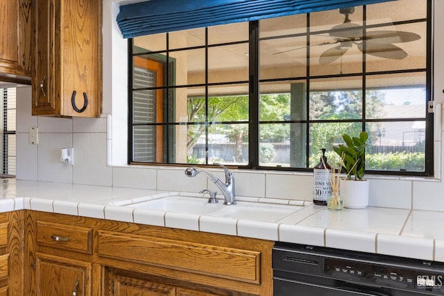 kitchen with dishwasher, brown cabinets, and decorative backsplash