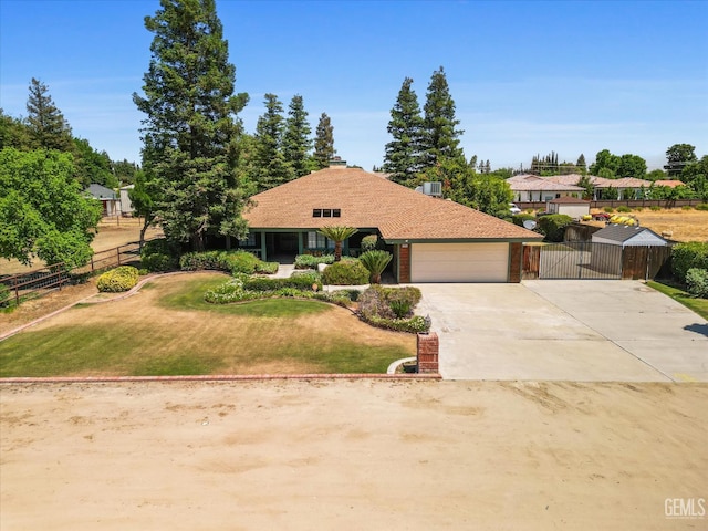 view of front of property with an attached garage, concrete driveway, and a gate