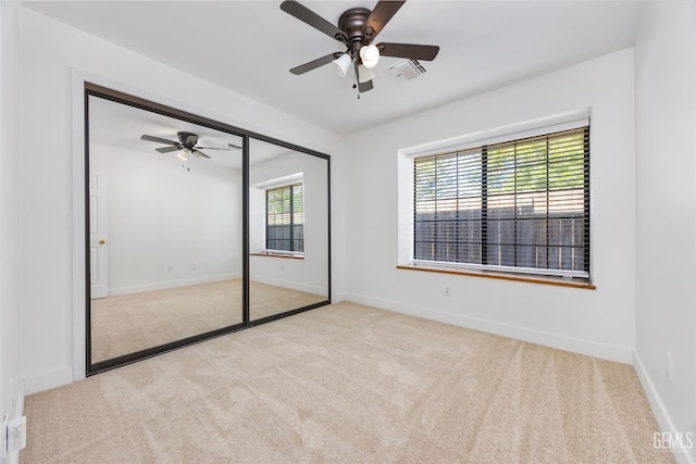 unfurnished bedroom featuring carpet flooring, baseboards, and a ceiling fan
