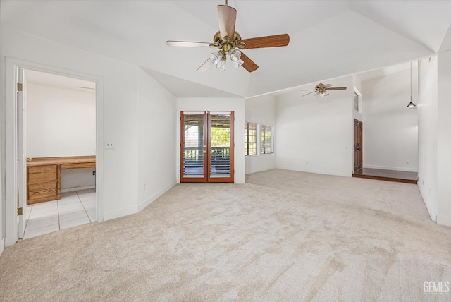 spare room featuring lofted ceiling, carpet floors, ceiling fan, and baseboards