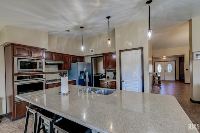 4716 Ambrister Dr, Bakersfield, CA 93313 - kitchen with a sink, decorative light fixtures, visible vents, under cabinet range hood, and appliances with stainless steel finishes