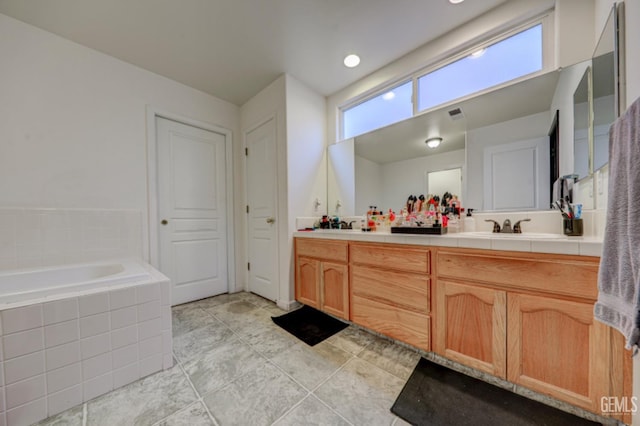 4716 Ambrister Dr, Bakersfield, CA 93313 - bathroom with a sink, visible vents, tile patterned floors, double vanity, and a bath
