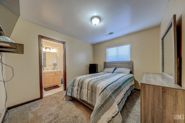 4716 Ambrister Dr, Bakersfield, CA 93313 - bedroom with baseboards, light carpet, connected bathroom, and visible vents