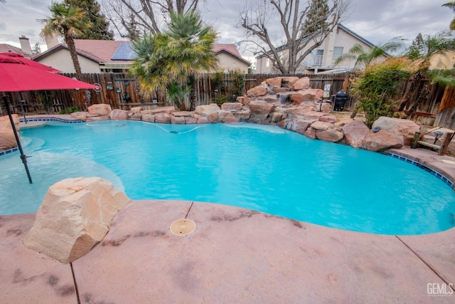 view of swimming pool featuring a patio area, a fenced in pool, and a fenced backyard