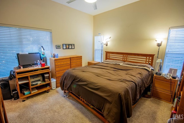 bedroom featuring light carpet and ceiling fan