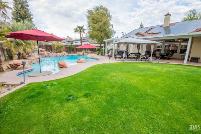 view of pool with a patio, a fenced in pool, a fenced backyard, a gazebo, and a lawn