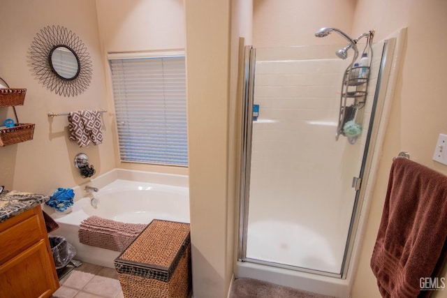 full bathroom with vanity, a shower stall, a bath, and tile patterned floors