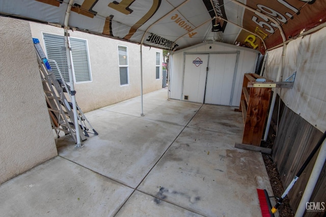 garage featuring a storage unit