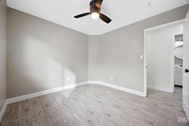 empty room featuring ceiling fan and light hardwood / wood-style flooring