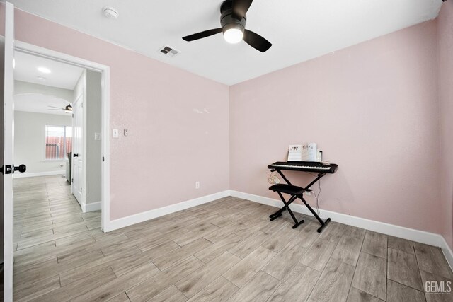 empty room featuring ceiling fan and light wood-type flooring