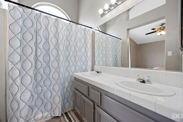 bathroom with vanity, curtained shower, and ceiling fan